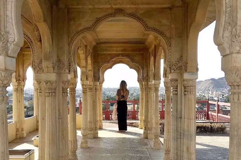 Solo traveler enjoying a reflective moment at a scenic heritage destination in India