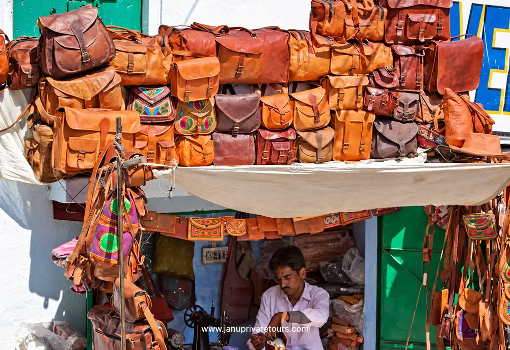 Leather bags and accessories displayed at a Udaipur market stall